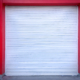White Roll-up Door on Red Wall of the Garage